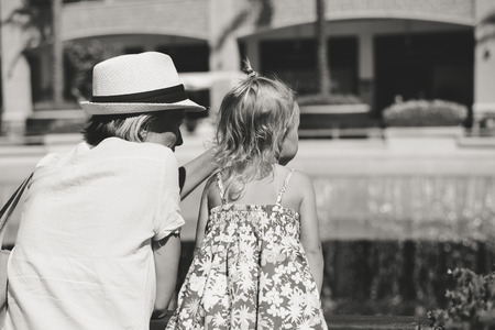 Rear view of mother and child on shopping center backgroundの写真素材