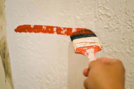 Closeup on hand painting decorating using paint brushの写真素材