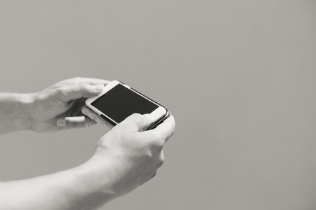 Closeup on smartphone in the hand, copy space backgroundの写真素材