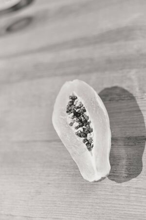 Top view of half cut fresh orange papaya fruit on wooden background. Closeup flat layの写真素材