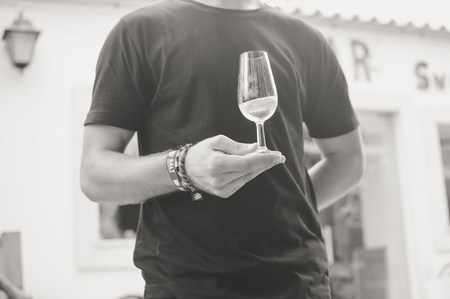 Albufeira, Portugal - August 03, 2016. Person waiter host presenting a wine bottle for tastingの写真素材