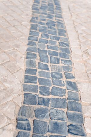 Top view on road or pavement made of natural stone, outdoors backgroundの写真素材