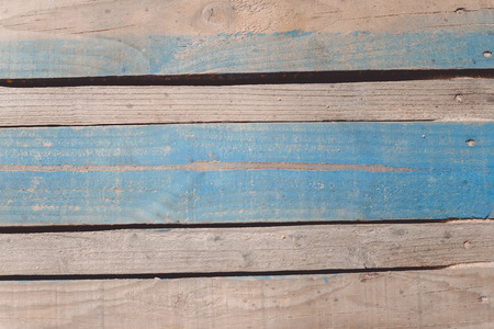 Top view of wooden beach boardwalk with sand texture backgroundの写真素材