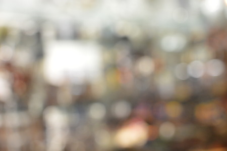 Blurry defocused bokeh lights background of night time festive city streets and shopsの写真素材