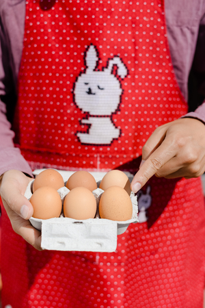 Selecting process. Hands holding shopping box of eggs. Closeup viewの写真素材