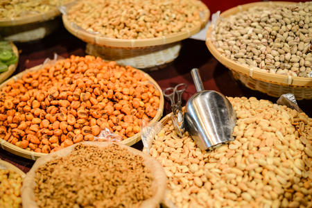 Colorful variety dry fruits and nuts in the street shop vibrant backgroundの写真素材
