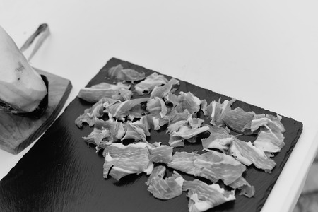 Dry cured ham thinly sliced. Closeup on slices of prosciutto Italian delicatessen. Festive time backgroundの写真素材