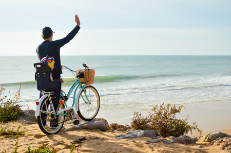 Defocused silhouette of child and father with bike on a beach natural outdoor. Travel vacation backgroundの写真素材