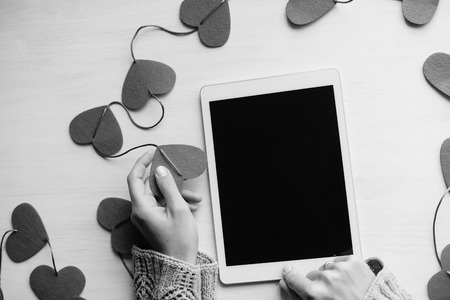 Love hearts symbol and woman hand holding tablet pc computer, valentine day background designの写真素材