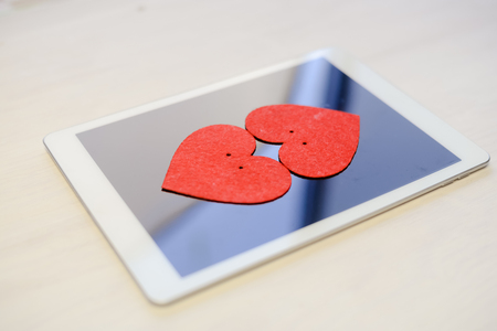 Tablet PC Computer and Love Heart. Happy Emotional Celebration, Lovely Atmosphere Backgroundの写真素材