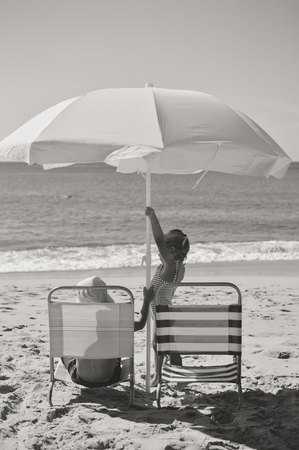 Back view of children having fun on the beach sunny outdoors backgroundの写真素材