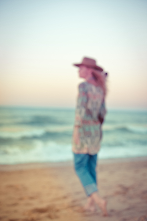 Defocused unrecognised person playing guitar on the beach backgroundの写真素材