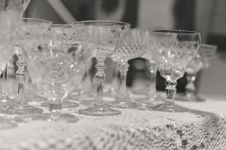 White table and row of beautiful glasses, celebration design set backgroundの写真素材