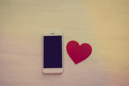 Love heart symbol and mobile phone, valentine day background designの写真素材