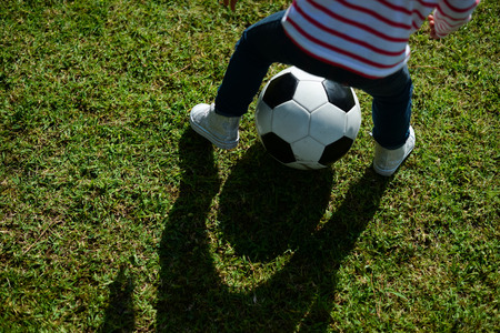 Family sporty football activity in the park on sunny outdoors backgroundの写真素材