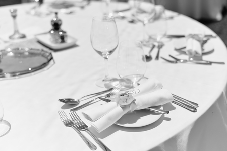 Elegant arrangement table setting for special event celebrating on outdoors backgroundの写真素材