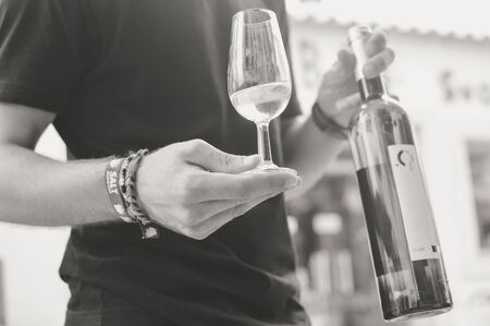Albufeira, Portugal - August 03, 2016. Person waiter host presenting a wine bottle for tastingのeditorial素材