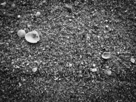 Black abstract natural sandy beach closeup, volcanic seacoast background. Space surface for text