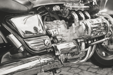 Close up on shiny chrome motorcycle details, silver background