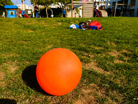 Playing ball on the playground sunny green outdoors backgroundの写真素材
