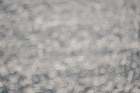 Abstract blurry effect sunny water surface, natural outdoors background, defocused backdrop photoの写真素材