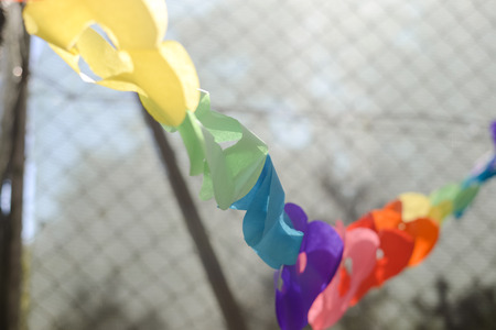 Symbolic chain of paper hearts connected together over nature backgroundの写真素材