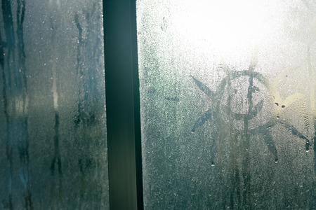 Foggy condensated window blurry textured outdoors background imageの写真素材