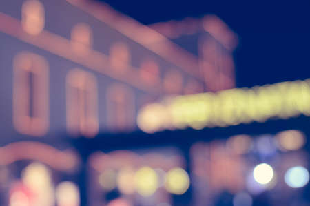 Abstract blurred bokeh urban street outdoors background, shallow depth of focus. Colorful defocused shiny night conceptの写真素材