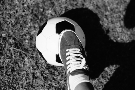 Parents with children playing soccer on green grass nature outdoors background. Childcare, school or weekend activityの写真素材