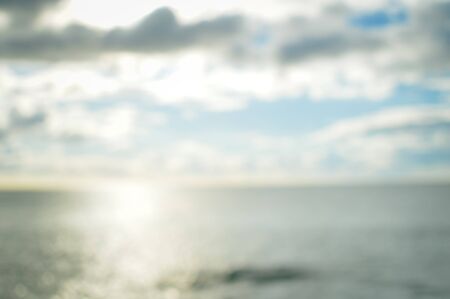 Abstract blurred ocean environment shiny colorful sunlight background. Travel vacation seasonal bright mood seascape glowing abstractionの写真素材