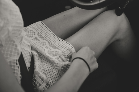 Closeup top view on attractive glamorous woman driving car. Blurred image