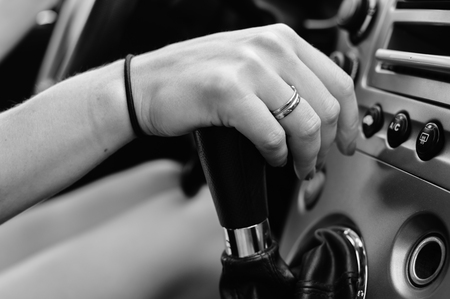 Closeup top view on attractive glamorous woman changing gear driving car. Blurred imageの写真素材