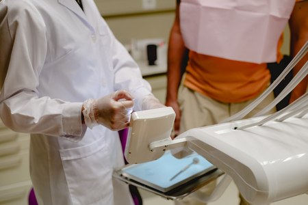Medical health care treatment procedure. The dentist treats a patient, dental machine office...
