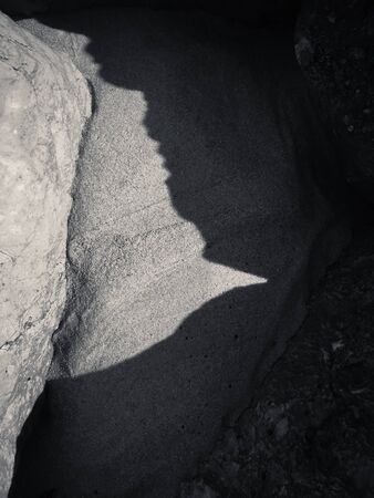 Macro closeup on natural surface of the rock stone dark textured backgroundの写真素材