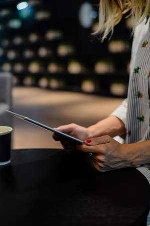 Business person using holding digital tablet mobile pc device over blurred background. Close up on technology conceptの写真素材