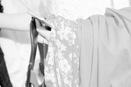 Fashion clothing hanging on hangers. Closeup on group of accessory, household showroom departmentの写真素材
