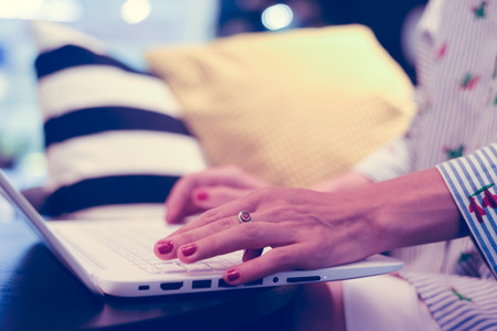 Closeup on sitting woman use laptop for business, creative project, researching study working process. Modern networking communication technology, abstract office indoors background. Content creationの写真素材