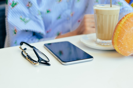 New York, USA - 12 August 2017: Closeup on hand using Apple Iphone 6S Plus smartphone over light table. Social business device, technology service. Top side mock up view of blank copy space displayのeditorial素材