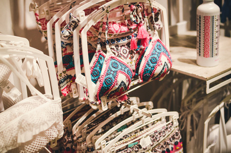Fashion underwear, clothing hanging on hangers. Closeup on group of accessory, household showroom departmentの写真素材