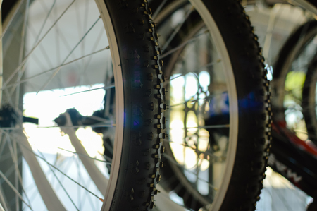 Close up on modern bikes detail over show room abstract shelf background, mobility cycle rangeの写真素材