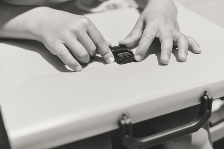Close up on schoolchild holding plastic folder, abstract educational background. Top side view imageの写真素材