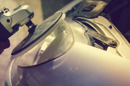 Automobile industry. Close up on car detail - male hand polish in auto repair shop background. Professional person during mechanical maintenance, industrial part transport renovationの写真素材