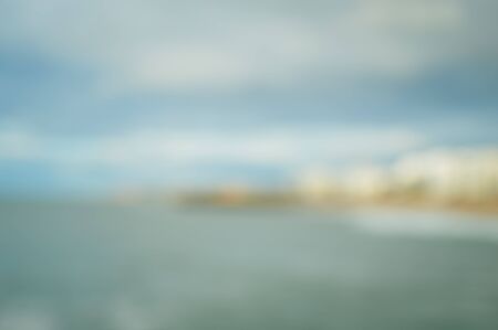 Defocused blurry beautiful sea coastline sun rays light outdoors natural background. Recreational tourism inspirational scenery photographの写真素材