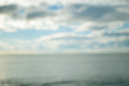 Defocused blurry beautiful sea coastline sun rays light outdoors natural background. Recreational tourism inspirational scenery photographの写真素材