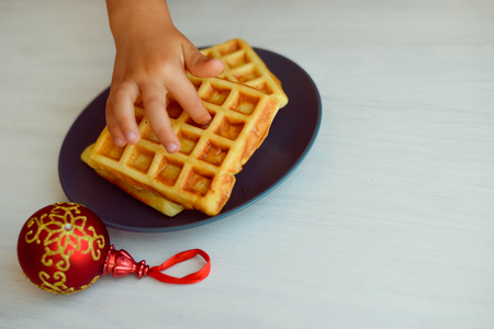 Homemade fresh golden waffles delicious breakfast. Top side close up view of healthy seasonal refreshment diet, texture background conceptの写真素材