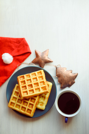 Homemade fresh golden waffles delicious breakfast. Top side close up view of healthy seasonal refreshment diet, texture background conceptの写真素材