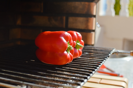 Close up on peppers ready for roasting on the grill, sunny day outdoors backgroundの写真素材