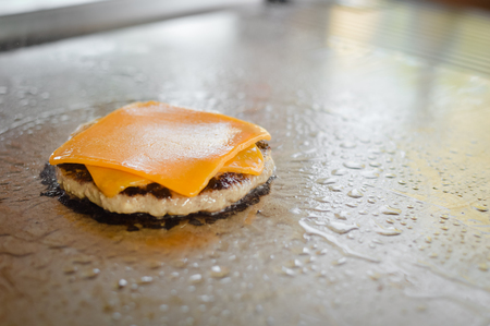 Burger on a stove background. Cooking delicious hamburger cheeseburger. Healthy fresh food hot heat for eatingの写真素材