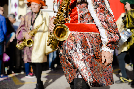 Joyful samba carnival unrecognizable performers on blurred street outdoors background. Amazed delighted dancing people enjoying festive happinessの写真素材