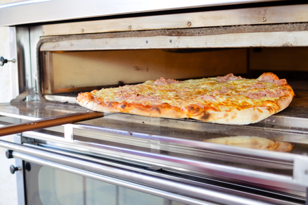 Fresh baked pizza italian cuisine, fast food abstract design background. Closeup photoの写真素材